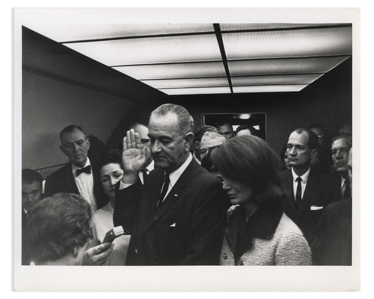 Cecil W. Stoughton's Personal, Unpublished Photo of LBJ's Inauguration Aboard Air Force One -- LBJ Takes the Oath of Office as Jackie Stands Witness